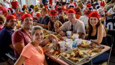 Annapolis Crab Feast_CREDIT Visit Annapolis (2).jpeg A group of people wearing crab hats enjoying the feast