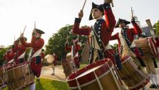 Fifers and drummers in colonial costume perform in front of the Governor's Palace in Williamsburg, Virginia, USA
